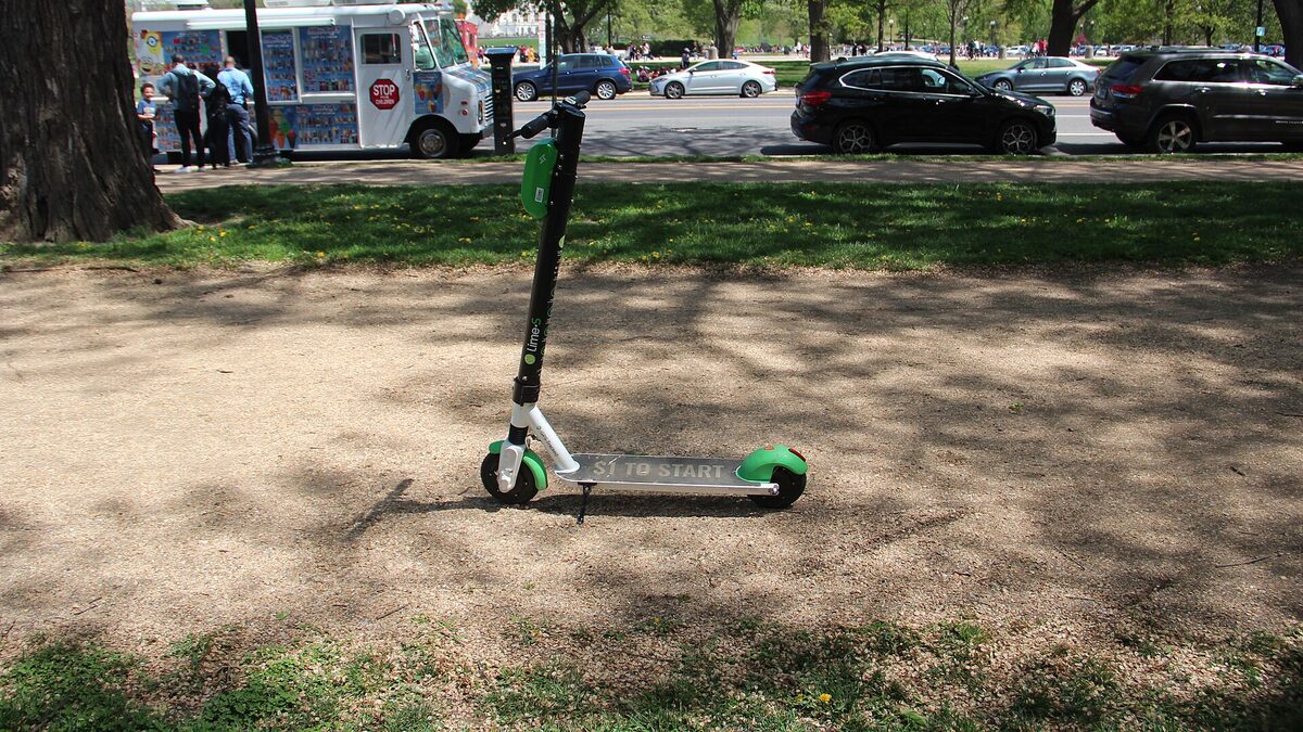 Shared electric kick scooter parked near a pedestrian path on the National Mall, Washington, DC