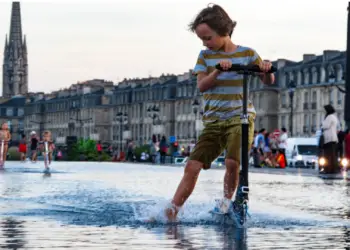 Riding scooter in wet condition image