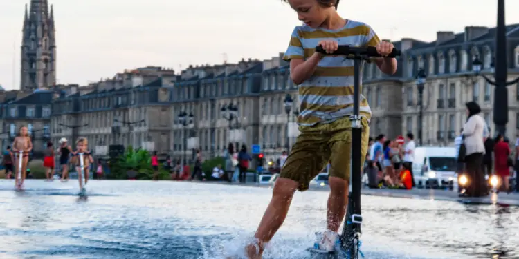 Riding scooter in wet condition image