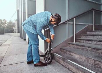 man locking scooter image