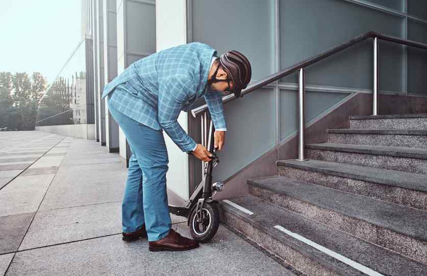 man locking scooter image